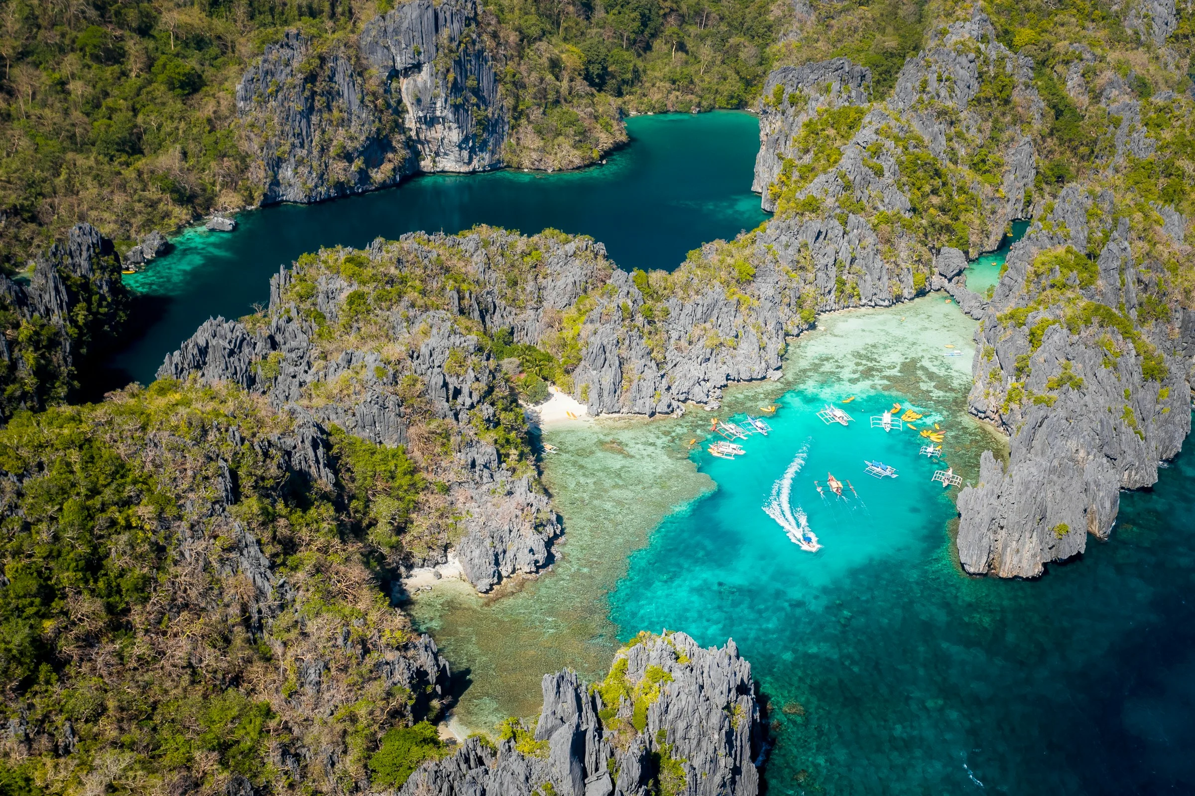 Aerial photograph of Big Lagoon and Small Lagoon in El Nido, Palawan, with limestone cliffs and turquoise water.